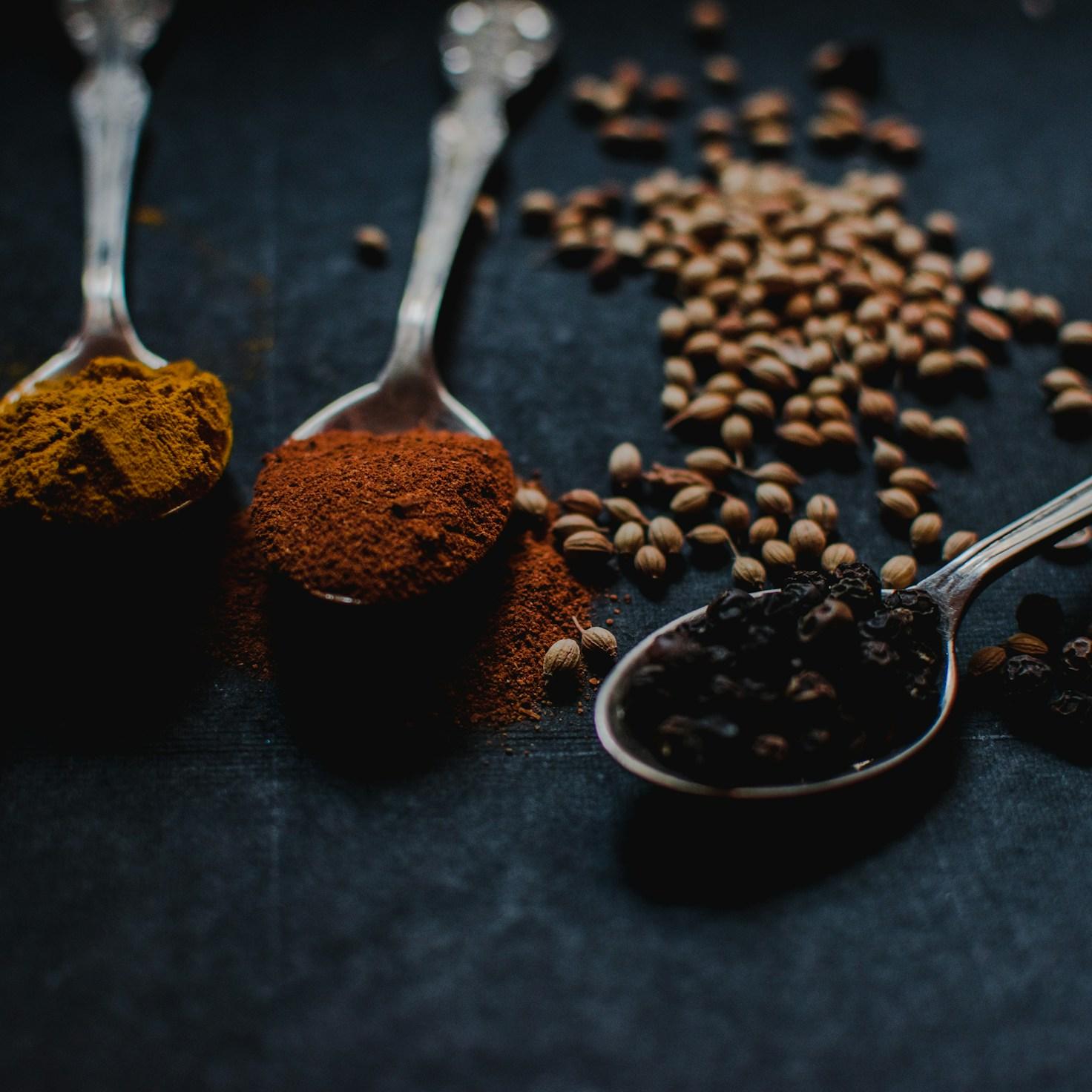 Diverse group of community members sharing a meal, highlighting the social bonds built through collaborative cooking